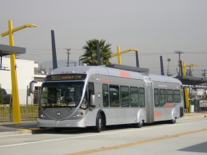 A Los Angeles Metro articulated bus travels along the Orange Line in the San Fernando Valley
